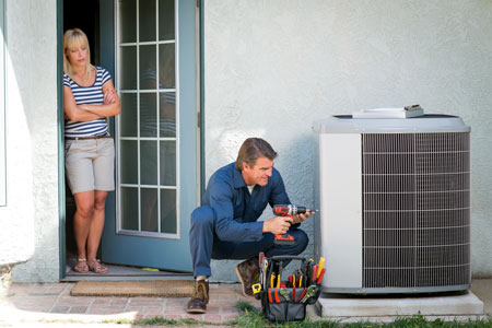 Air conditioning repair being performed by a technician in Alexander City, AL